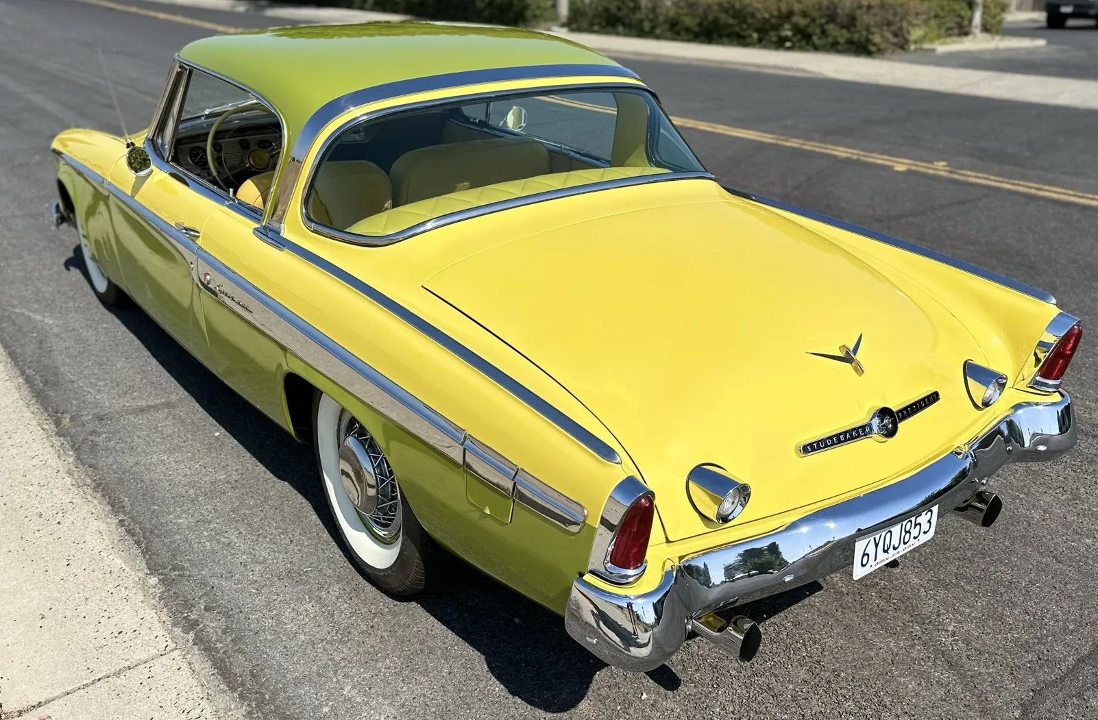 Studebaker Hawk: How Studebaker Made A Mess Of This Raymond Loewy Classic, And How Brooks Stevens Brought It Back 12 Left rear 3q view of a yellow and green 1955 Studebaker hardtop coupe