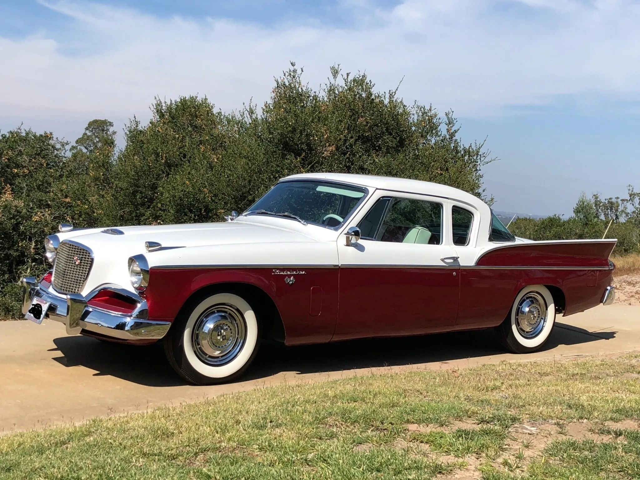 Studebaker Hawk: How Studebaker Made A Mess Of This Raymond Loewy Classic, And How Brooks Stevens Brought It Back 21 Left front 3q view of a two-tone 1957 Studebaker Silver Hawk pillared coupe
