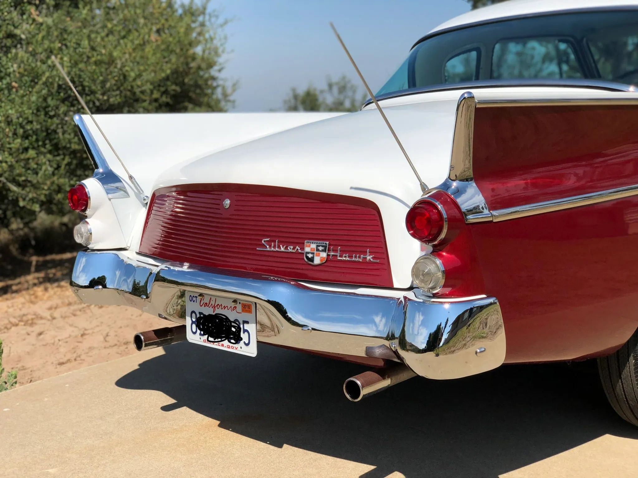 Studebaker Hawk: How Studebaker Made A Mess Of This Raymond Loewy Classic, And How Brooks Stevens Brought It Back 22 Rear end and tail fins of a white and red 1957 Studebaker Silver Hawk