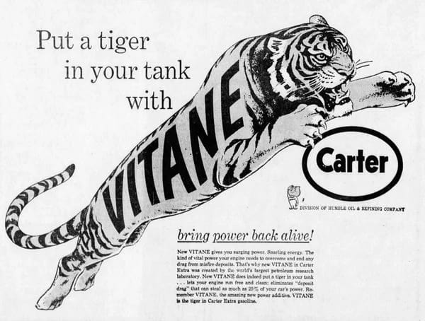 Carter Oil ad showing a leaping tiger with the word "VITANE" on its body, with the headline "Put a tiger in your tank with VITANE" and the slogan "bring power back alive!"