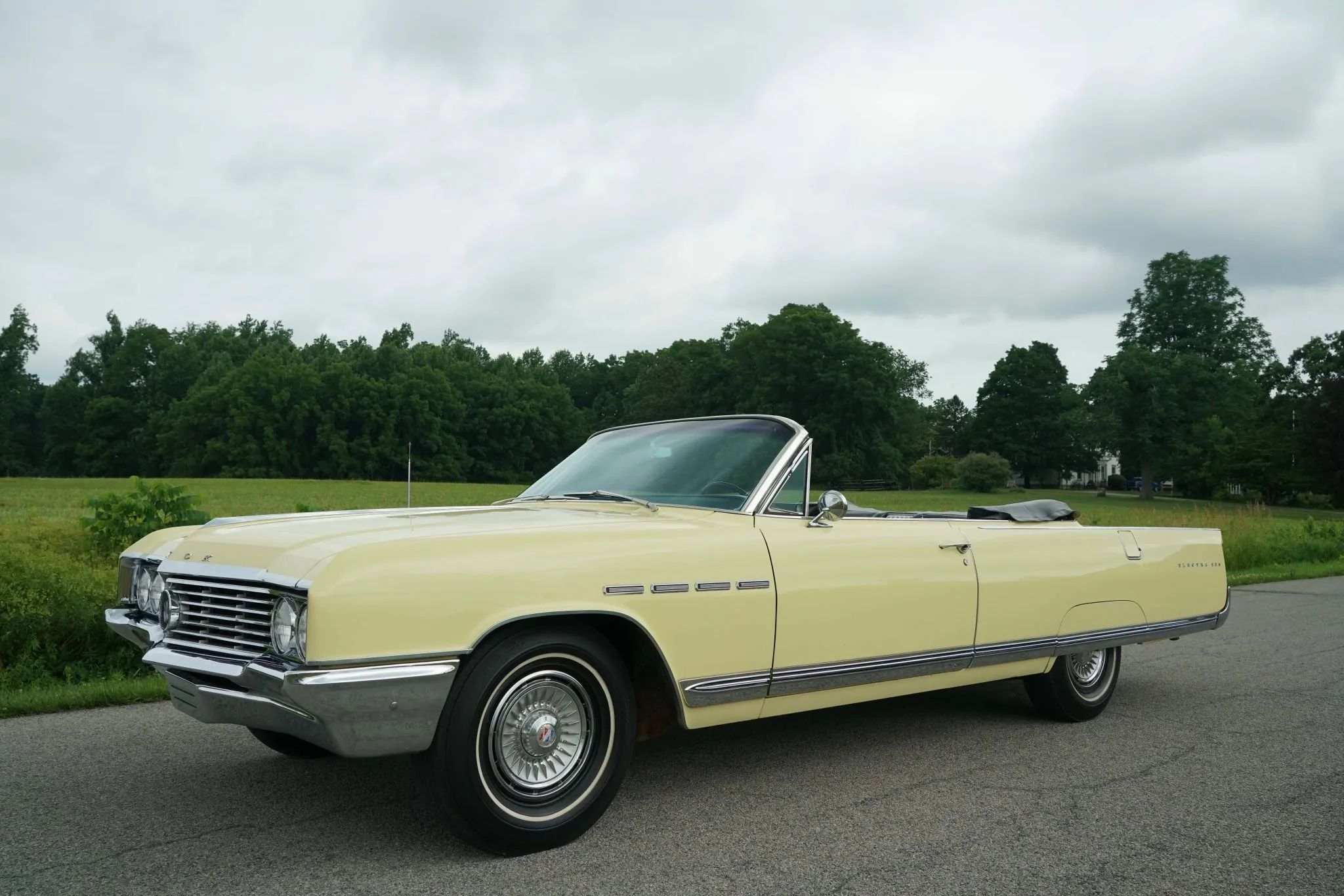 Grand Theft Auto: Four Examples Of American Design Forgery From The Big Three And Beyond 5 Picture of yellow 1964 Buick Electra 225 Convertible with the top down in front of a field