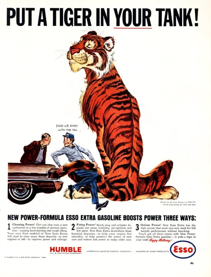 Esso "Put a Tiger in Your Tank" ad showing a gas station attendant trying to stuff the tail of a giant cartoon tiger into a car's fuel filler, saying "First we start with the tail ..."