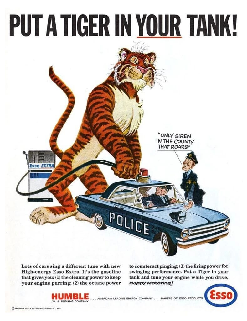 1965 Esso "Put a Tiger in Your Tank" ad showing the giant cartoon tiger adding Esso Extra to the fuel tank of a police car while one of the cops exclaims, "Only siren in the county that roars"