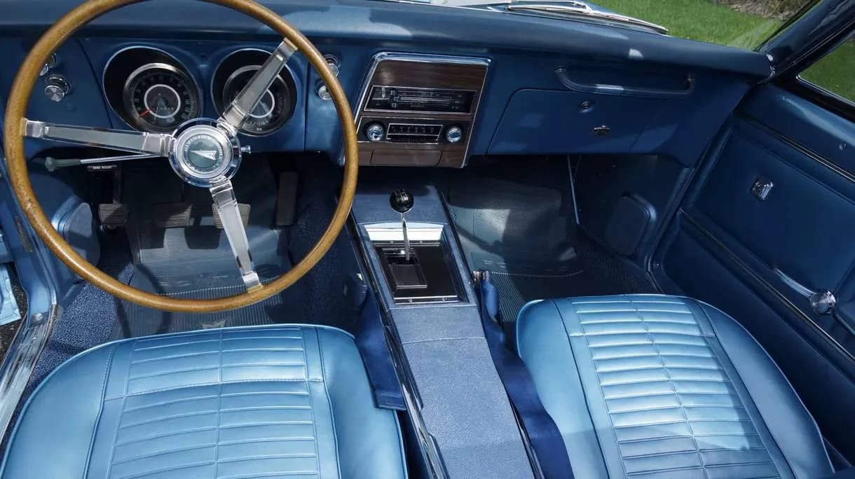 Front seats, steering wheel, and center console of a 1967 Firebird