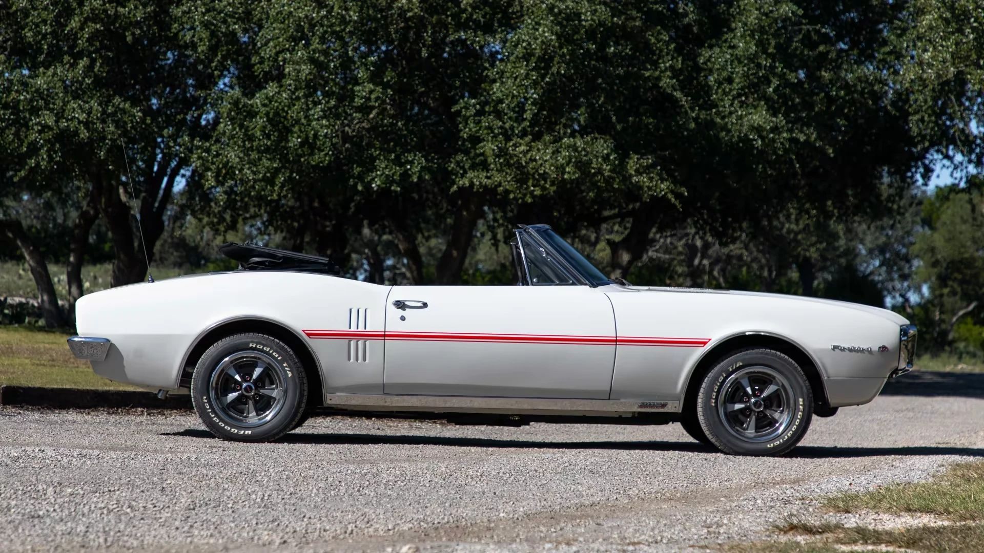 Right side view of a white 1967 Firebird convertible with the top down