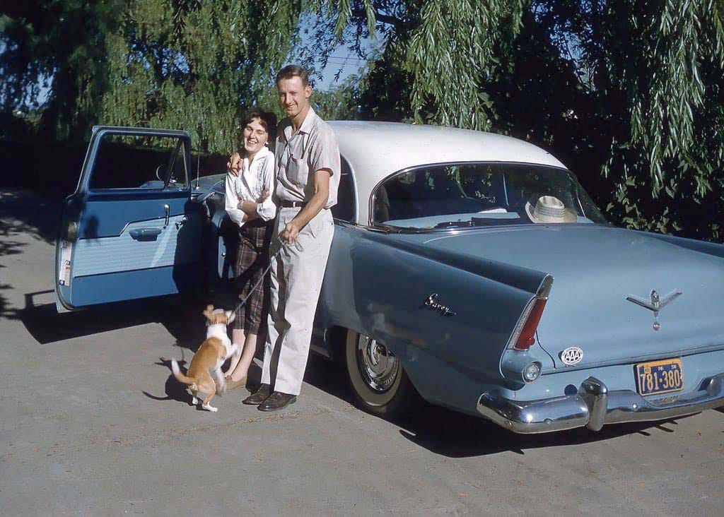 Couples and Classic Cars in Vintage Photos from the 1950s and 1960s 1 Vintage photo of a 1956 Plymouth Savoy Club Sedan with a couple standing next to it
