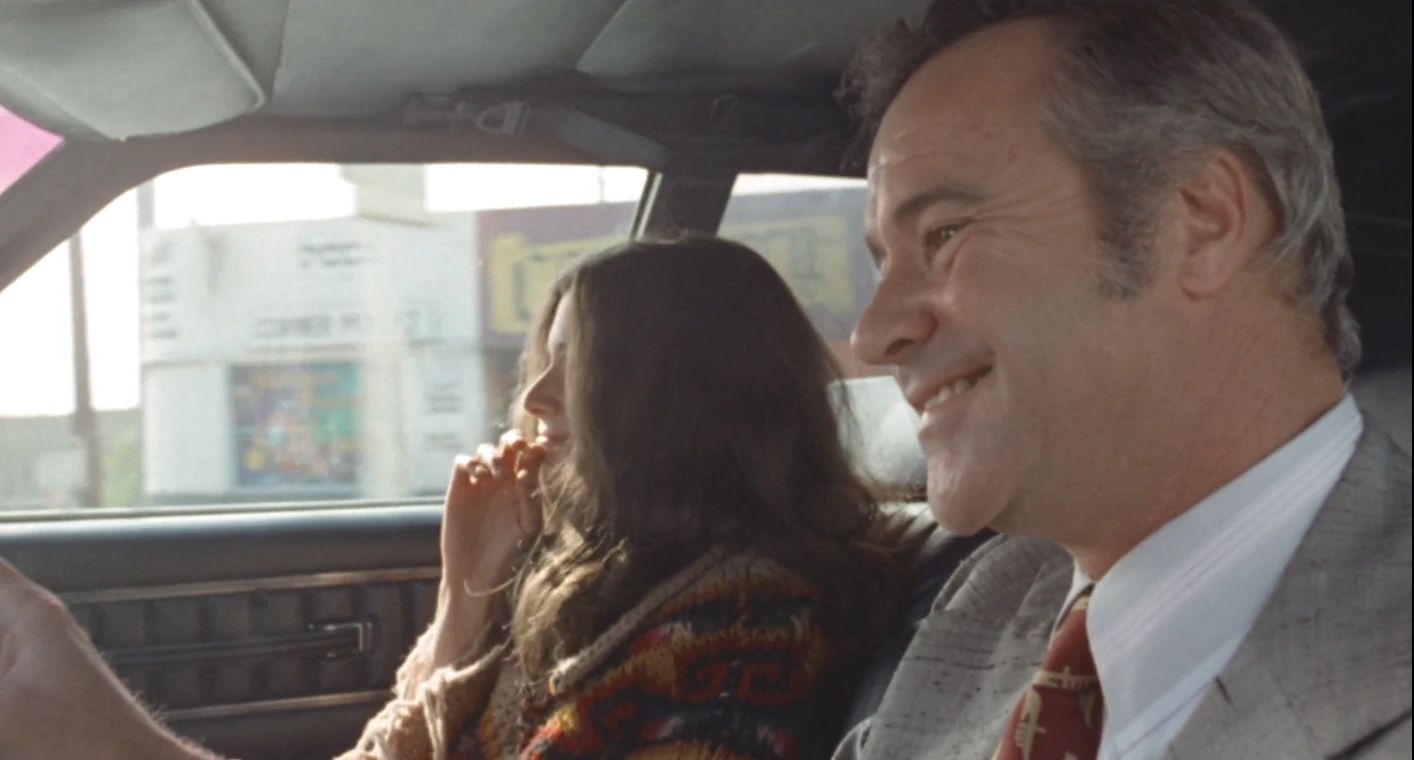 Why The 1972 Lincoln Continental Was The Perfect Movie Costar In This Jack Lemmon Drama 10 Movie screenshot of Jack Lemmon and Laurie Heineman in the front seat of a 1972 Lincoln, both smiling