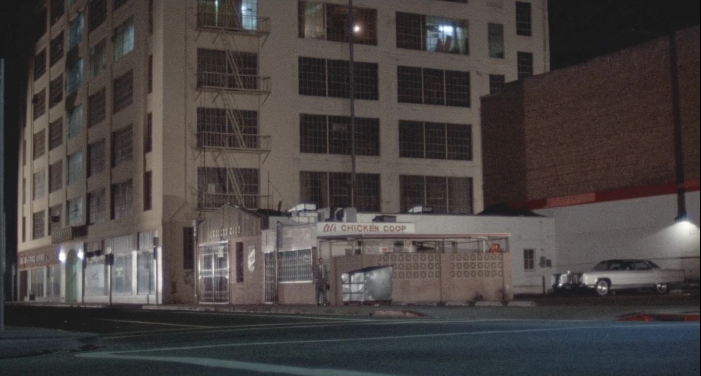 Why The 1972 Lincoln Continental Was The Perfect Movie Costar In This Jack Lemmon Drama 14 Movie screenshot of a parking lot in downtown Los Angeles, with the small figure of Jack Lemmon walking to a gray 1972 Lincoln Continental sedan