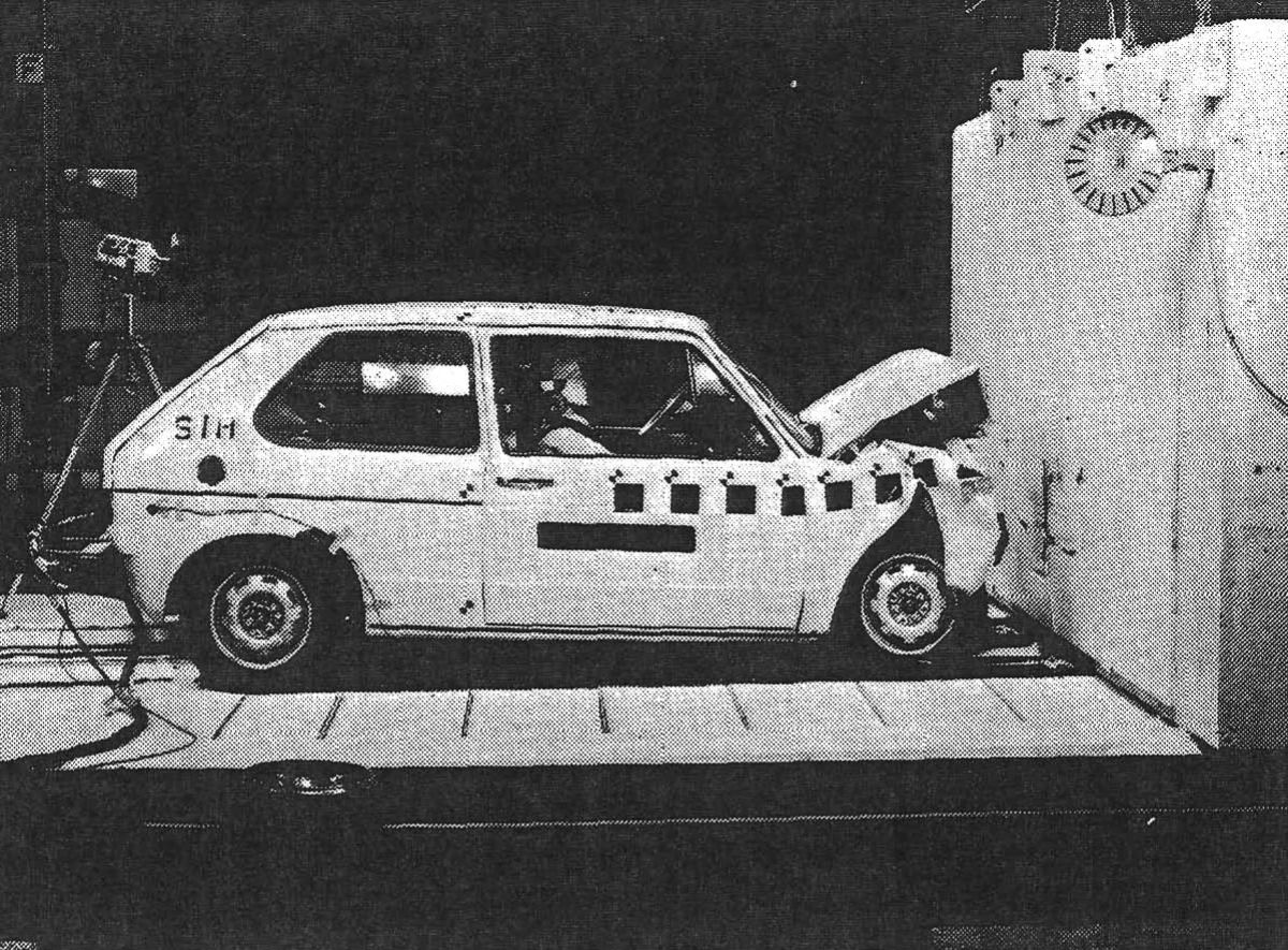 Volkswagen Automatic Seatbelt System: VW First Offered These Door-Mounted Passive Restraints Back In 1975 3 B&W photo of a barrier crash test of a 1975 VW Golf three-door