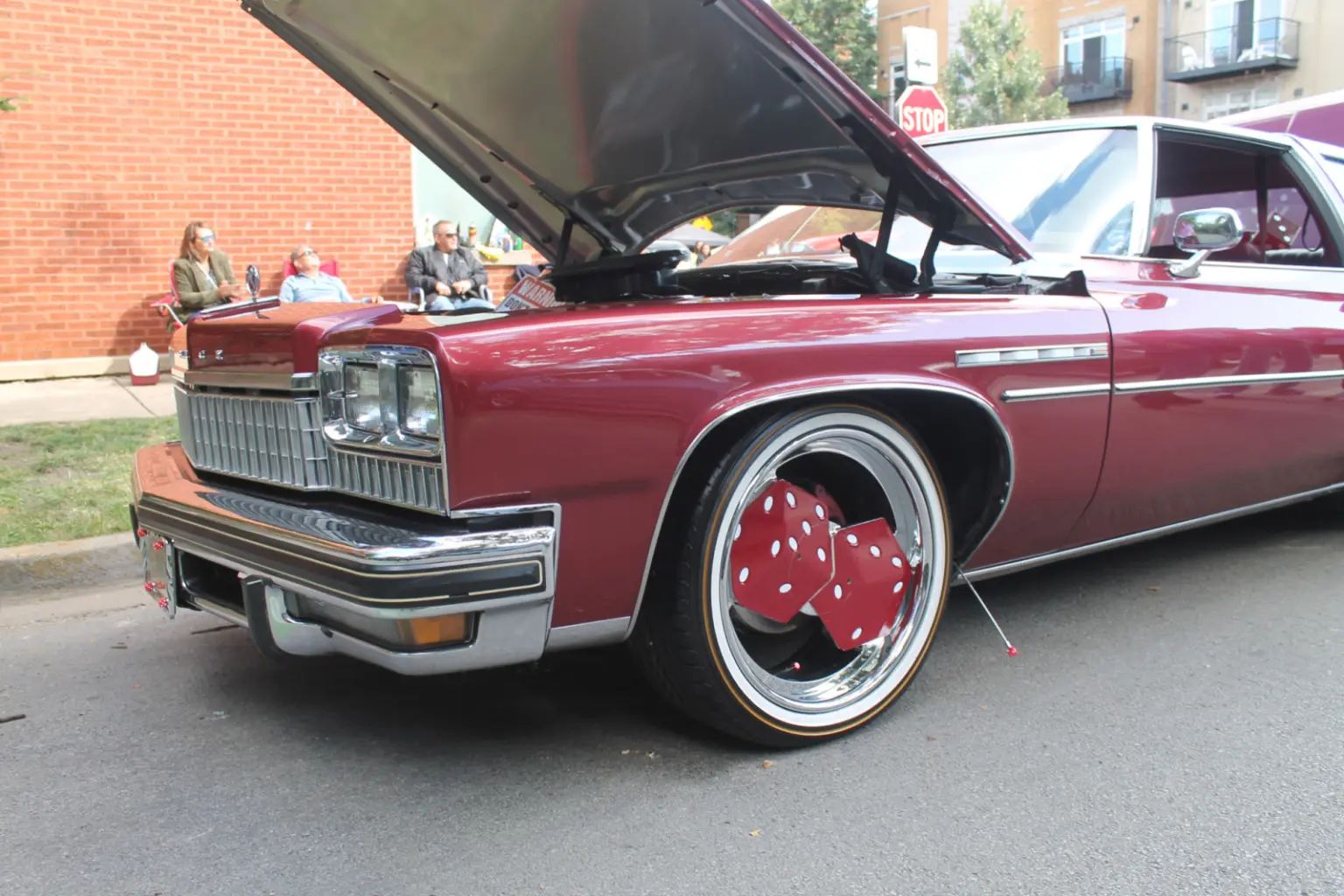 1975 Buick Electra 225 Custom Coupe – Roll The Dice 1 1975 Buick Electra 225 Custom Coupe with aftermarket dice rims, on display at street corner
