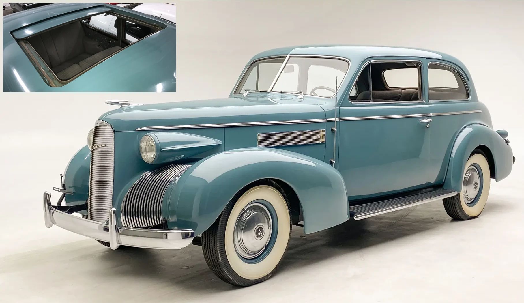 Left front 3q view of a blue 1939 LaSalle two-door sedan with an inset in the corner showing the car's sliding sunroof