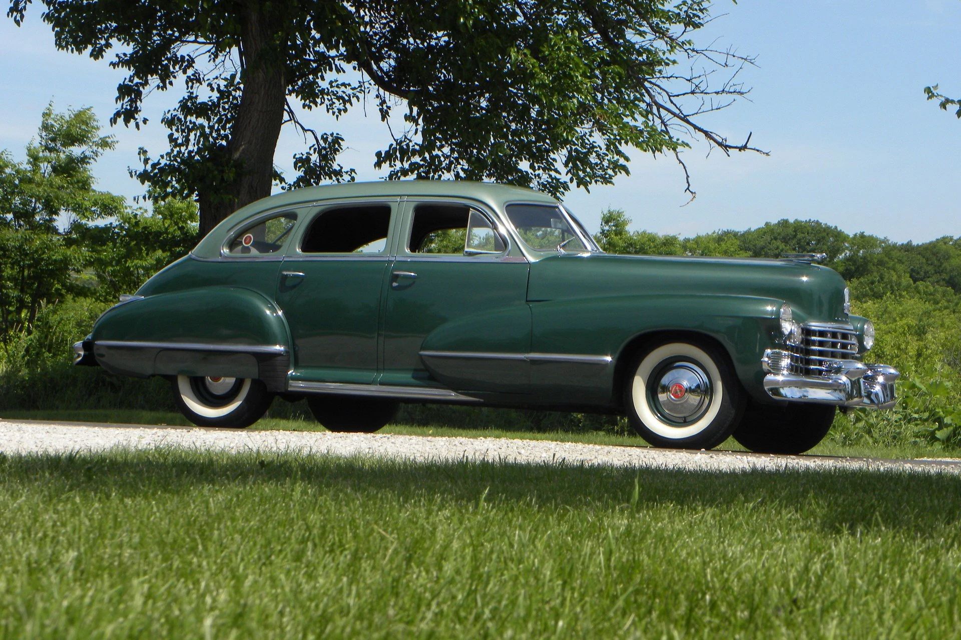 This WW2 Tank Is Powered By Twin Cadillac Engines And Hydra-Matic Transmissions, And It Was Parked Down The Street 6 Right front 3q view of a two-tone green 1942 Cadillac sedan