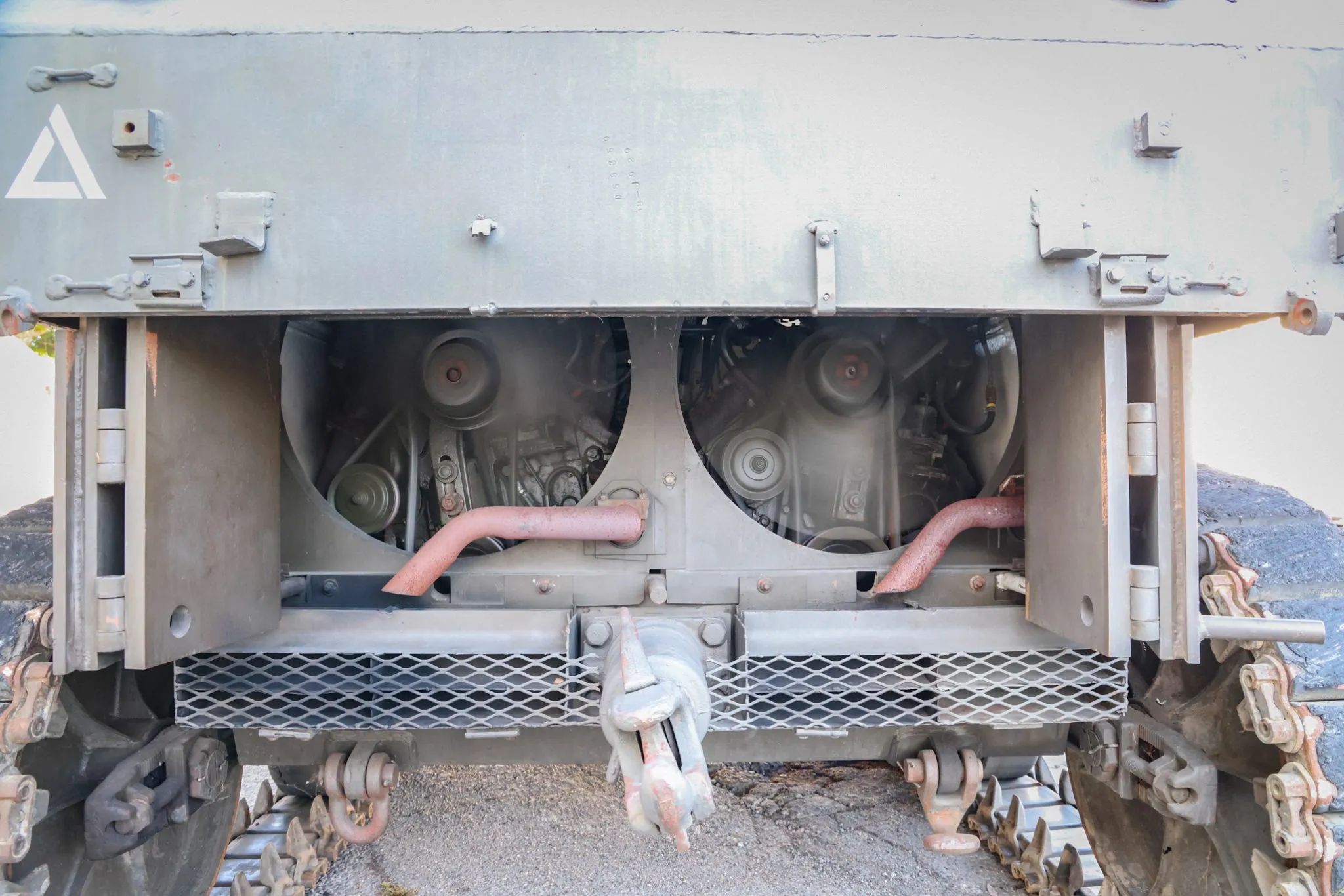 This WW2 Tank Is Powered By Twin Cadillac Engines And Hydra-Matic Transmissions, And It Was Parked Down The Street 8 Rear view of the engines in a light tank; both are running, causing the fans to blur