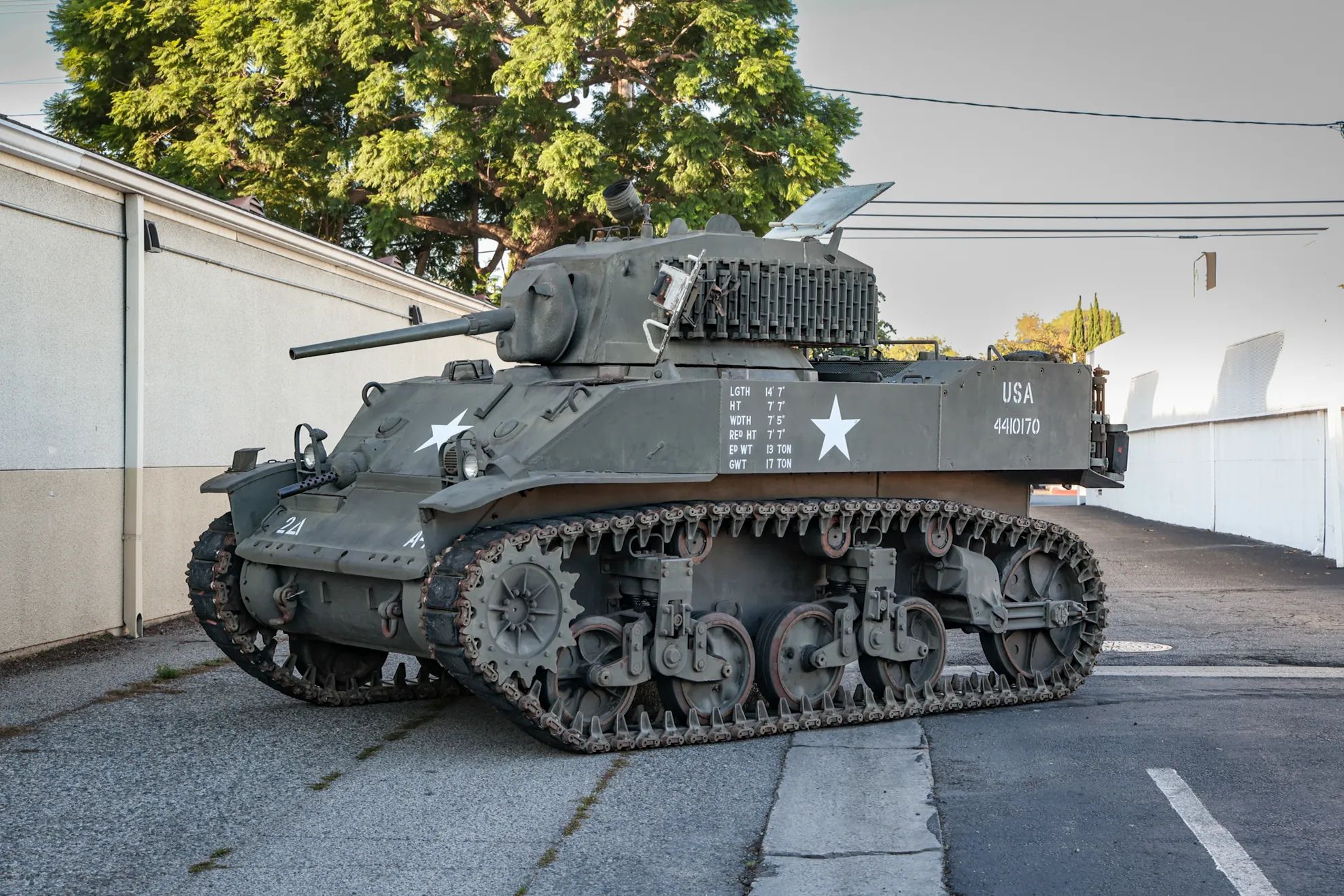 This WW2 Tank Is Powered By Twin Cadillac Engines And Hydra-Matic Transmissions, And It Was Parked Down The Street 1 Left front 3q view of an M5A1 light tank in a driveway
