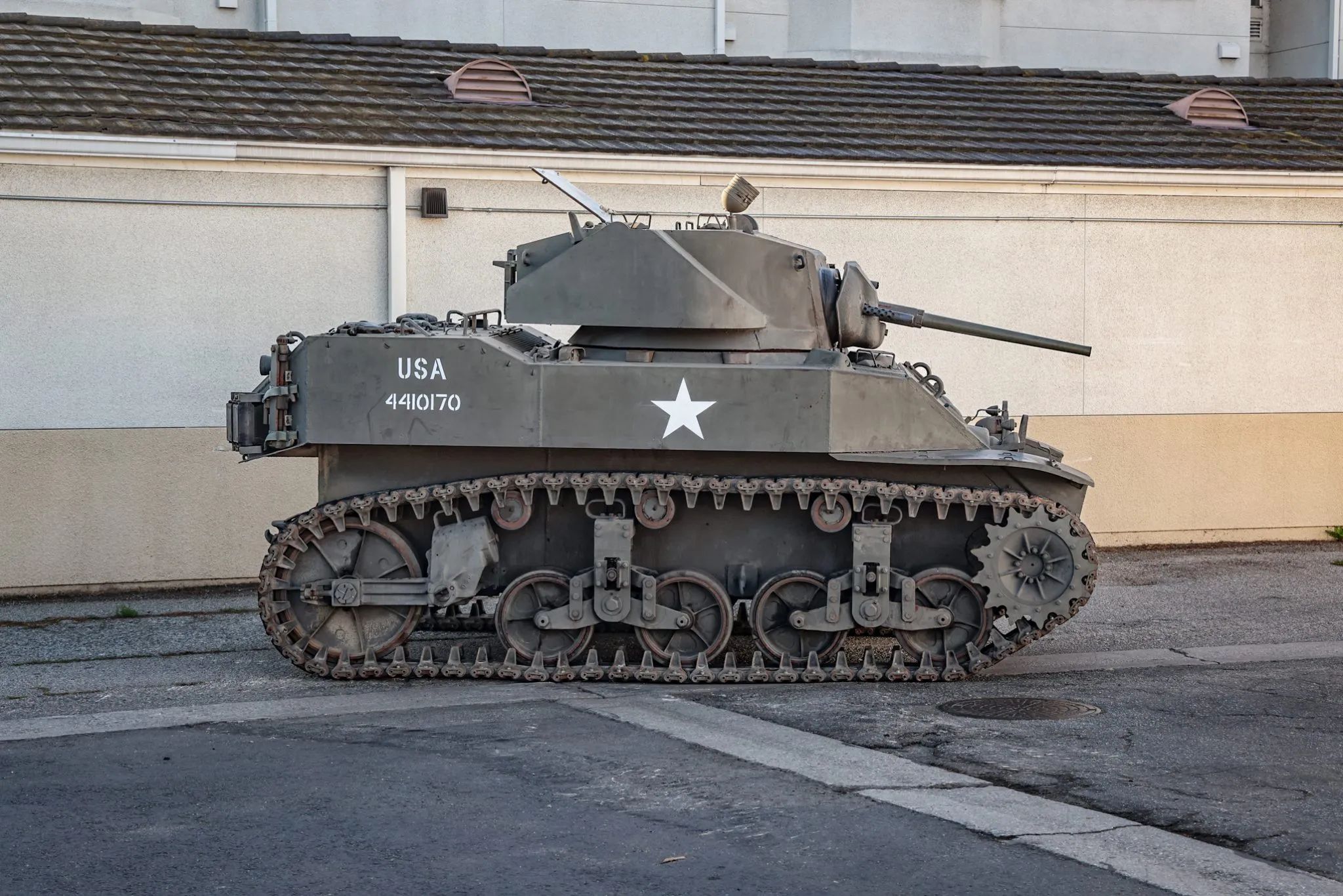 This WW2 Tank Is Powered By Twin Cadillac Engines And Hydra-Matic Transmissions, And It Was Parked Down The Street 4 Side view of an olive drab light tank
