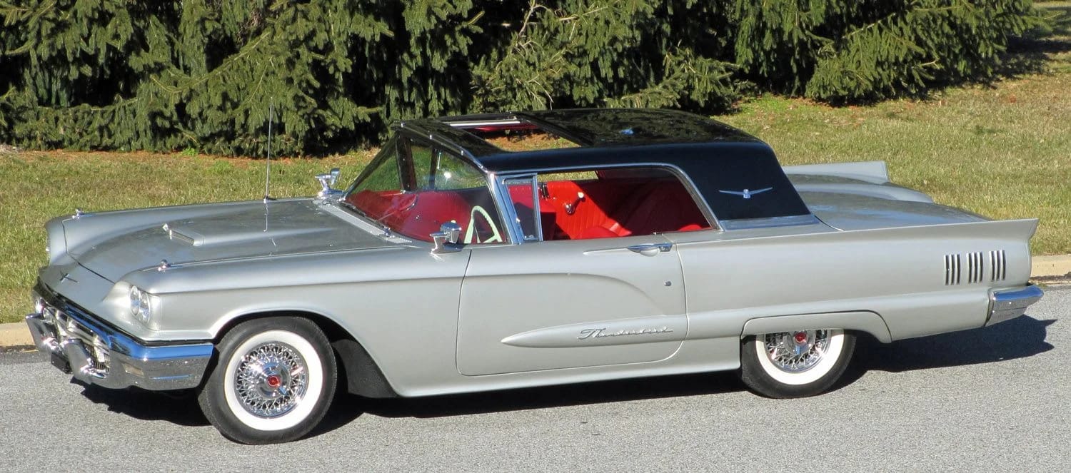 Left front 3q view of a silver and black 1960 Thunderbird with a sunroof