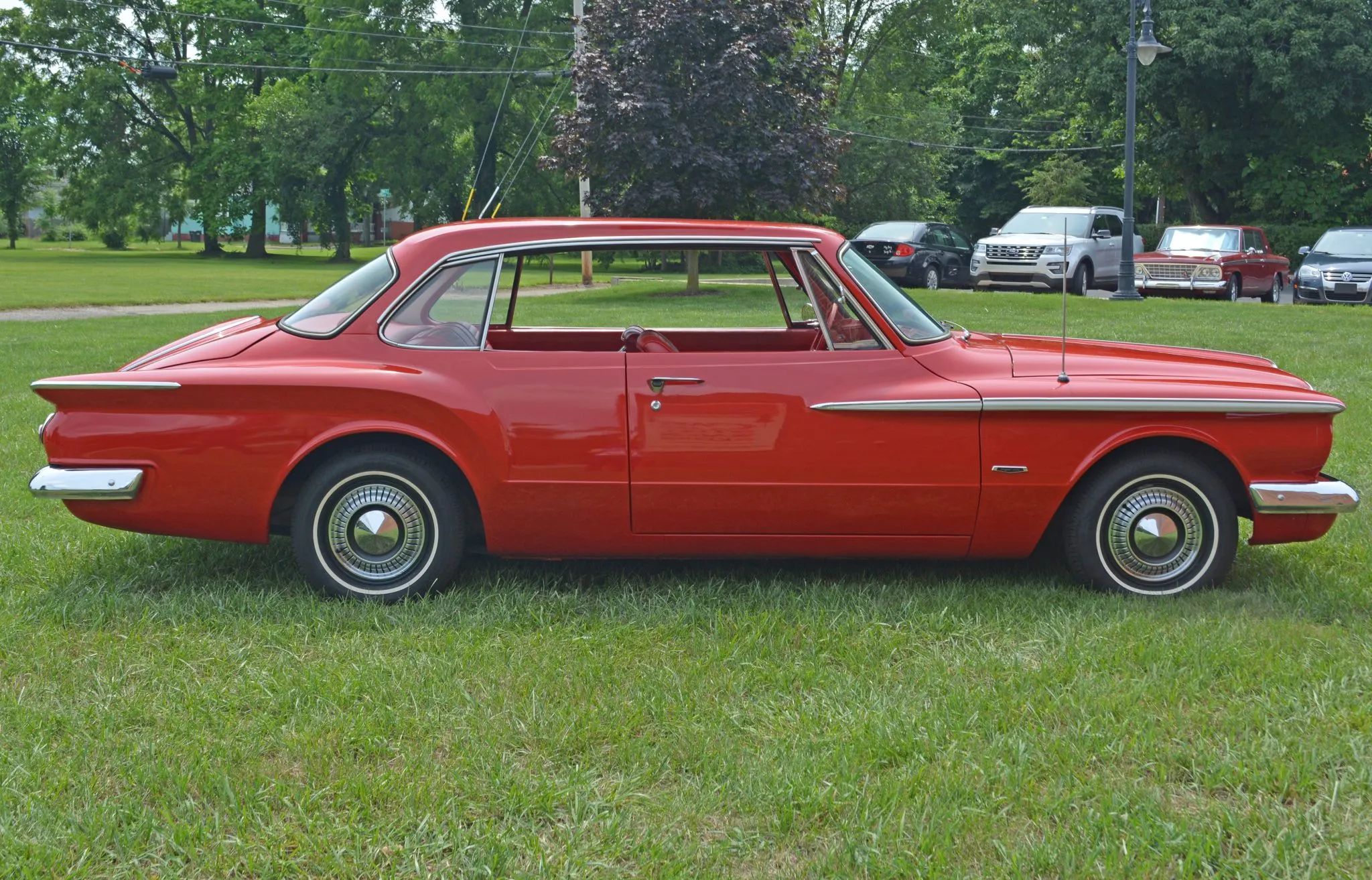 Right side view of a 1962 Plymouth Valiant two-door hardtop parked on grass
