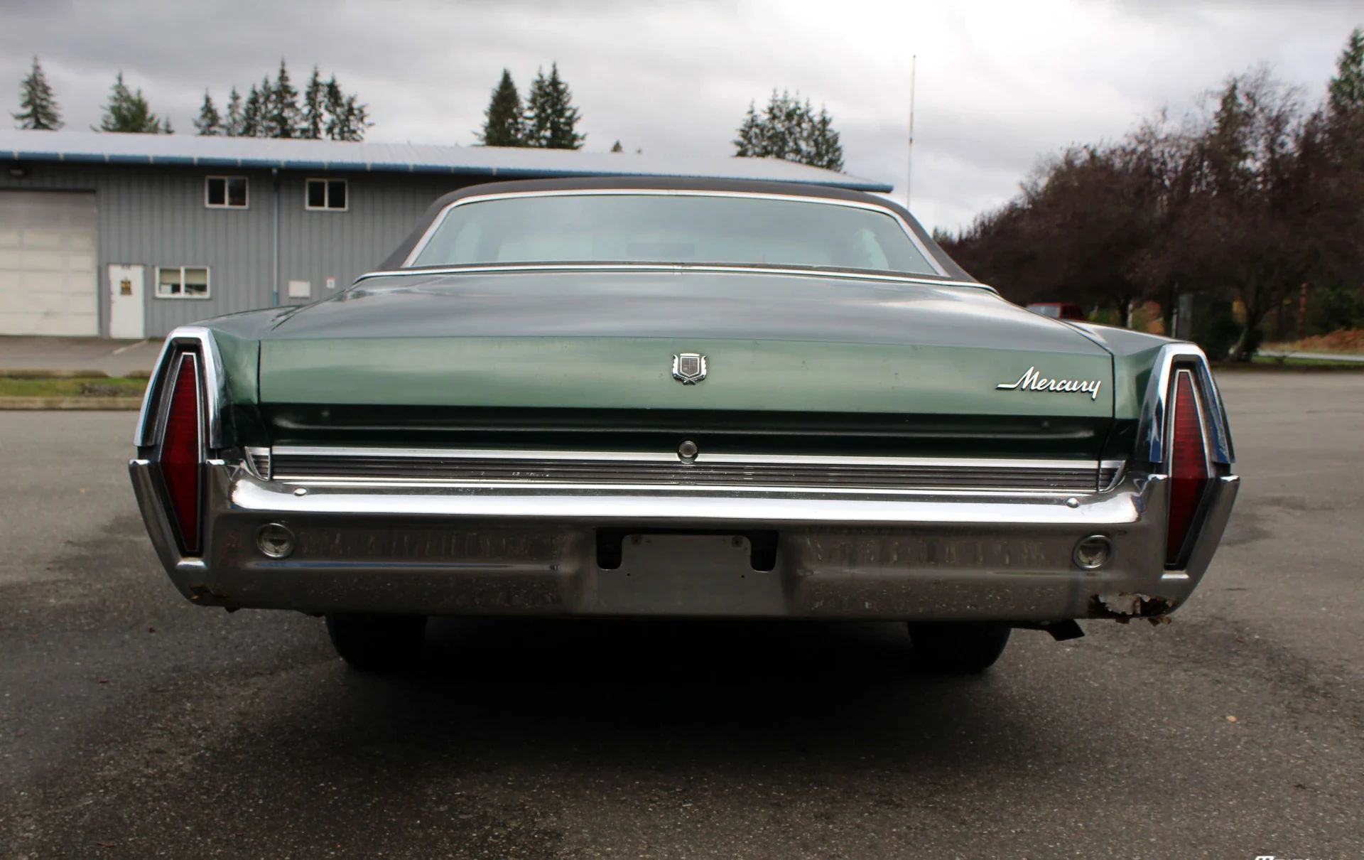 Vintage Car Life Review: 1967 Mercury Marquis — "Has The American Public Gone Soft?" 19 Rear view of a dark green 1967 Mercury