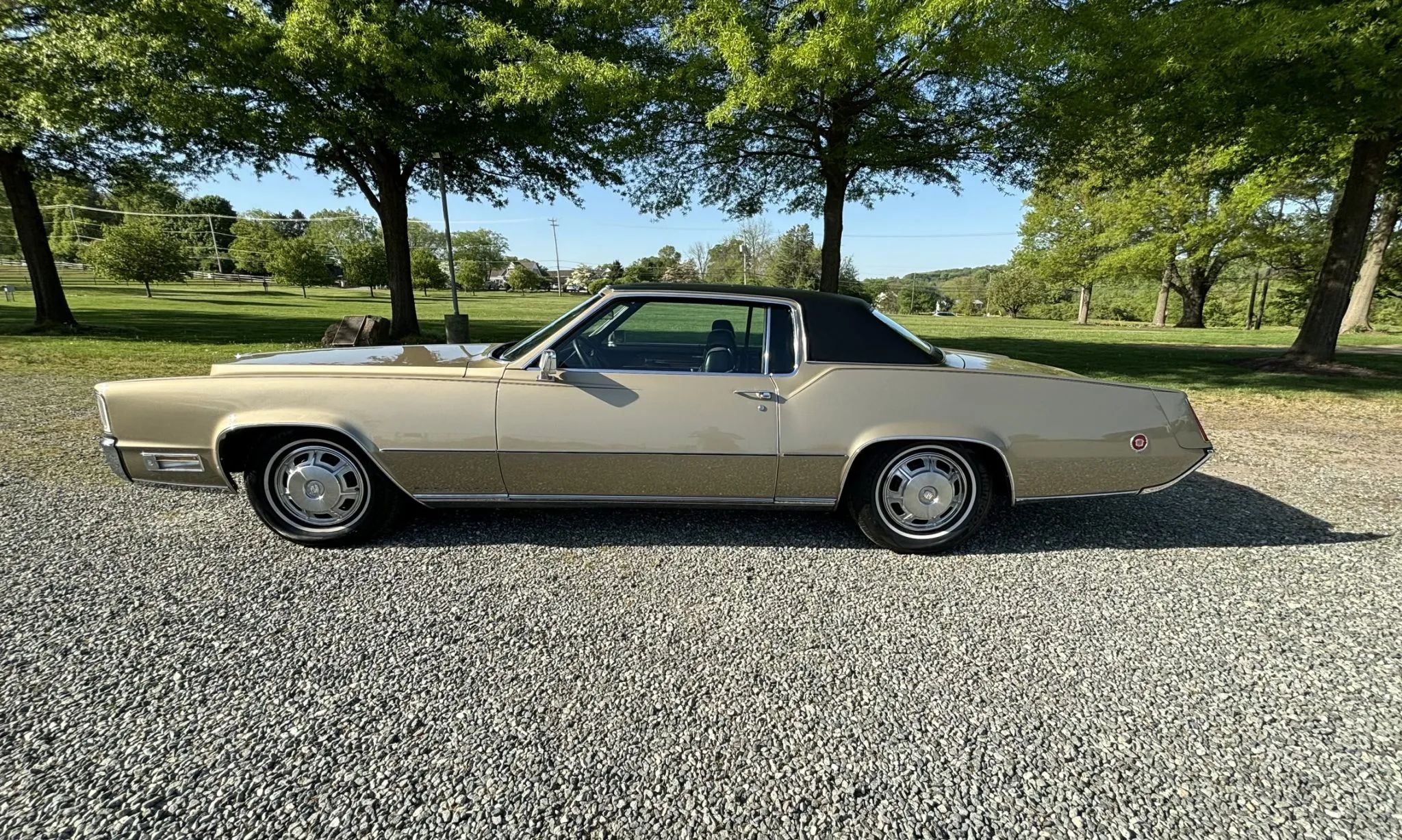 1974 Oldsmobile Toronado: Only 92 Miles And No Power Windows On This Triple-Green FWD Personal Luxury Coupe 4 Left side view of a light gold 1970 Cadillac Eldorado