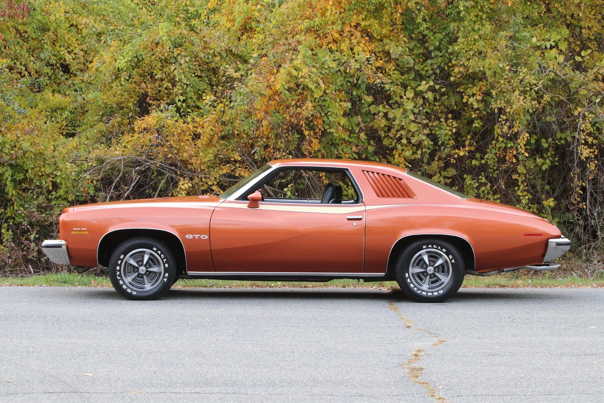 1973 Pontiac LeMans Sport Coupe: The Poor Man's GTO, With A 3-Speed Manual Transmission 4 Left side view of an orange 1973 Pontiac LeMans coupe