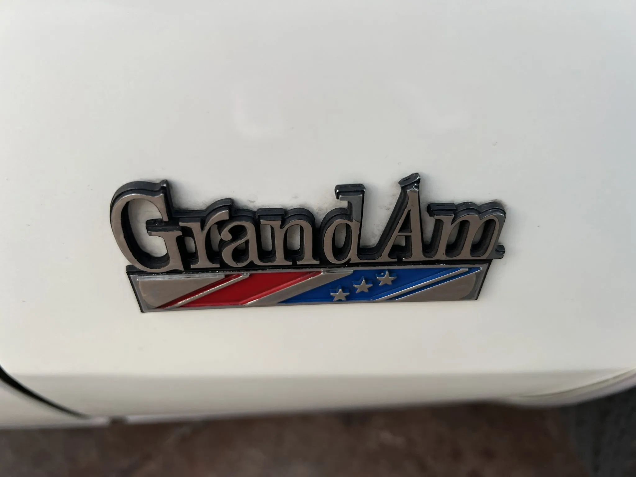 Grand Am fender badge on a white 1973 Pontiac