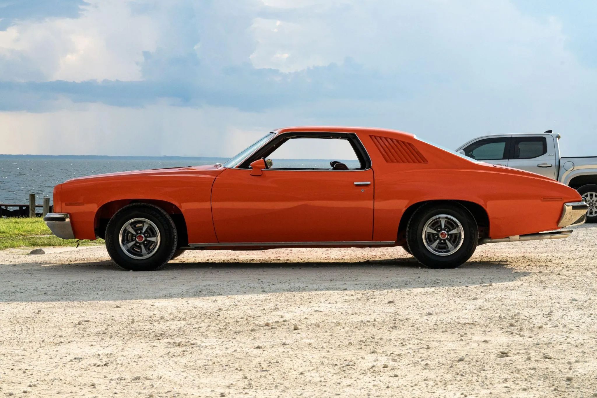 1973 Pontiac LeMans Sport Coupe: The Poor Man's GTO, With A 3-Speed Manual Transmission 6 Left side view of an orange 1973 Pontiac Colonnade coupe