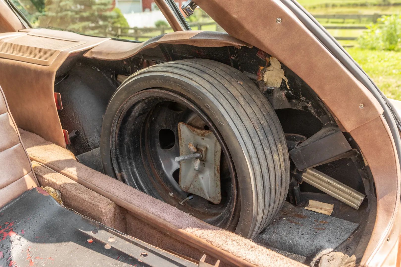 Spare tire in the right rear cargo area of an Eldorado wagon conversion