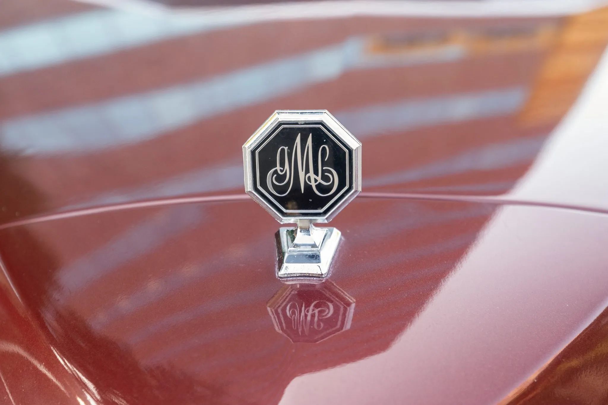 1976 Pontiac Grand LeMans: The Forgotten Colonnade, With Two Doors Or Four 7 Hood ornament on a maroon Pontiac
