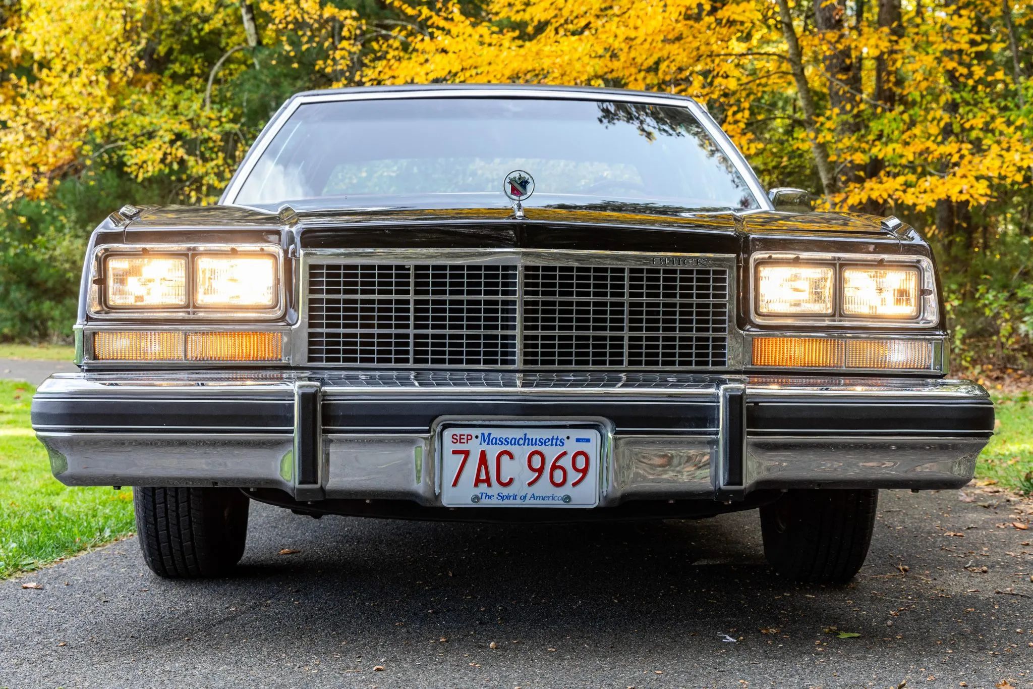 Front view of a 1977 Buick Electra with its headlights on