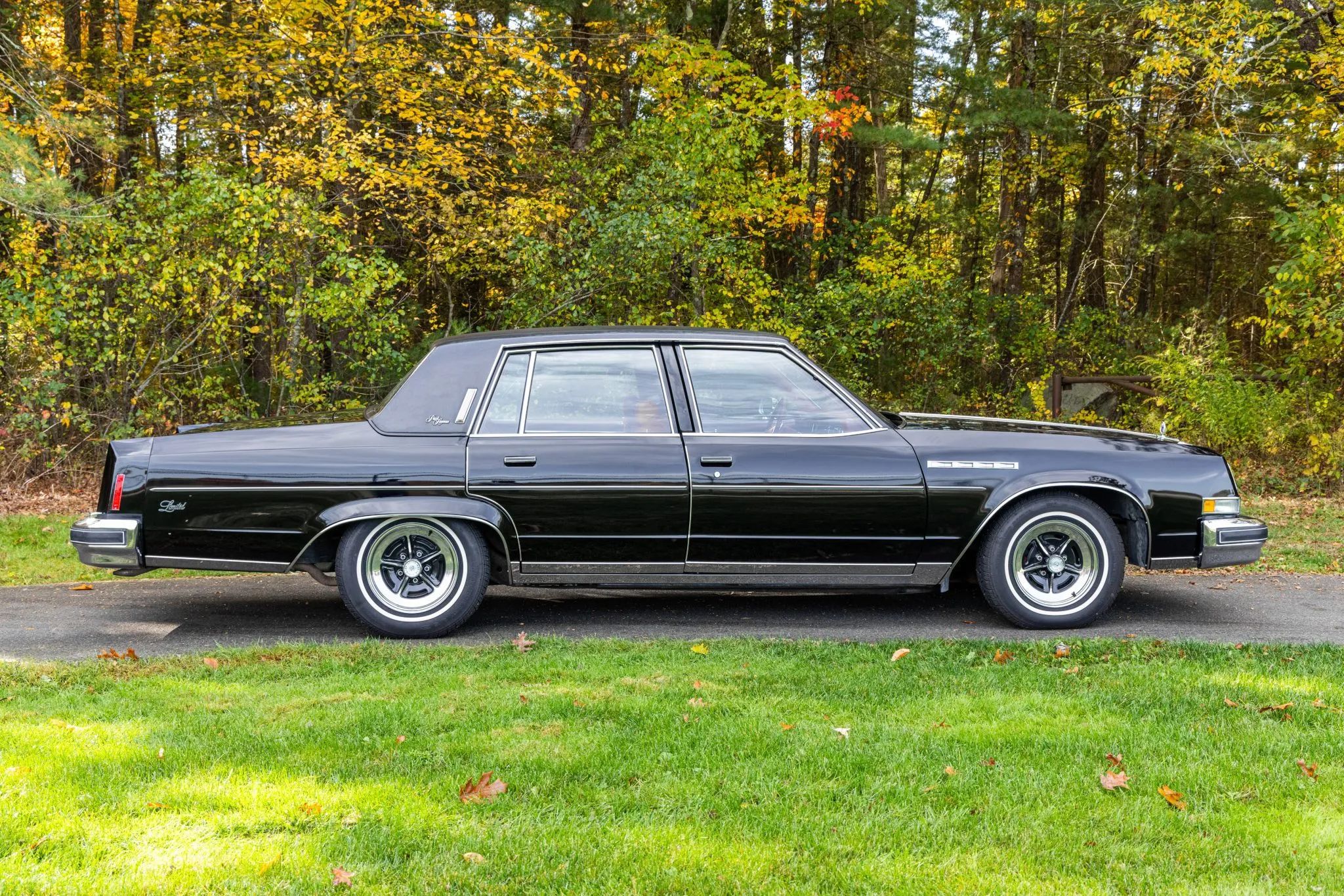 Right side view of a black four-door 1977 Buick Electra Park Avenue with styled steel wheels