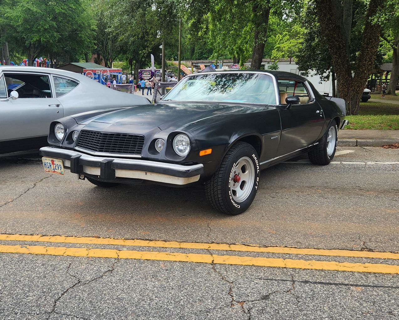 Living With 2nd and 3rd Gen Camaros Through the Years 1 1977 Camaro parked in the street at a car show.