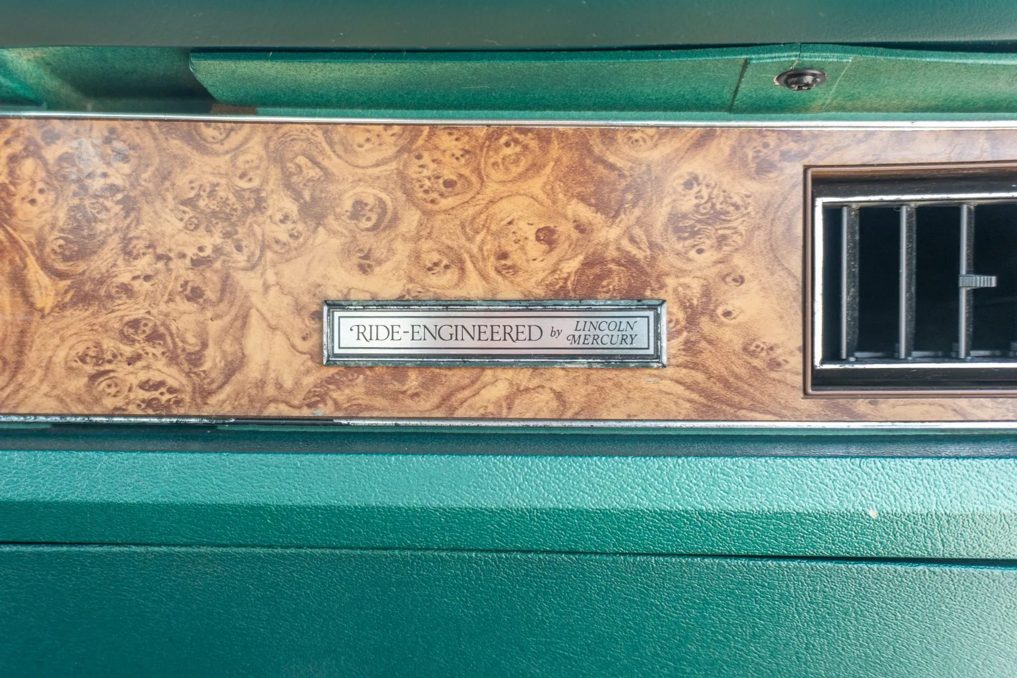 "Ride-Engineered by Lincoln-Mercury" plaque on the dashboard of a 1977 Mercury