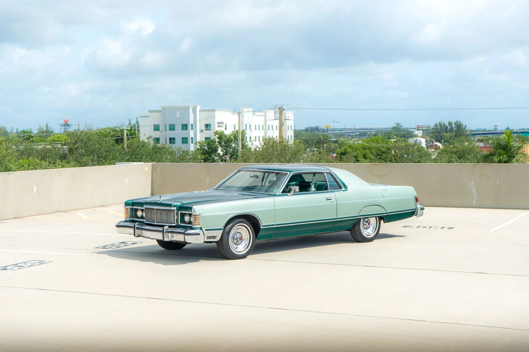 High-angle left front 3q view of a 1977 Grand Marquis on the roof of a parking structure