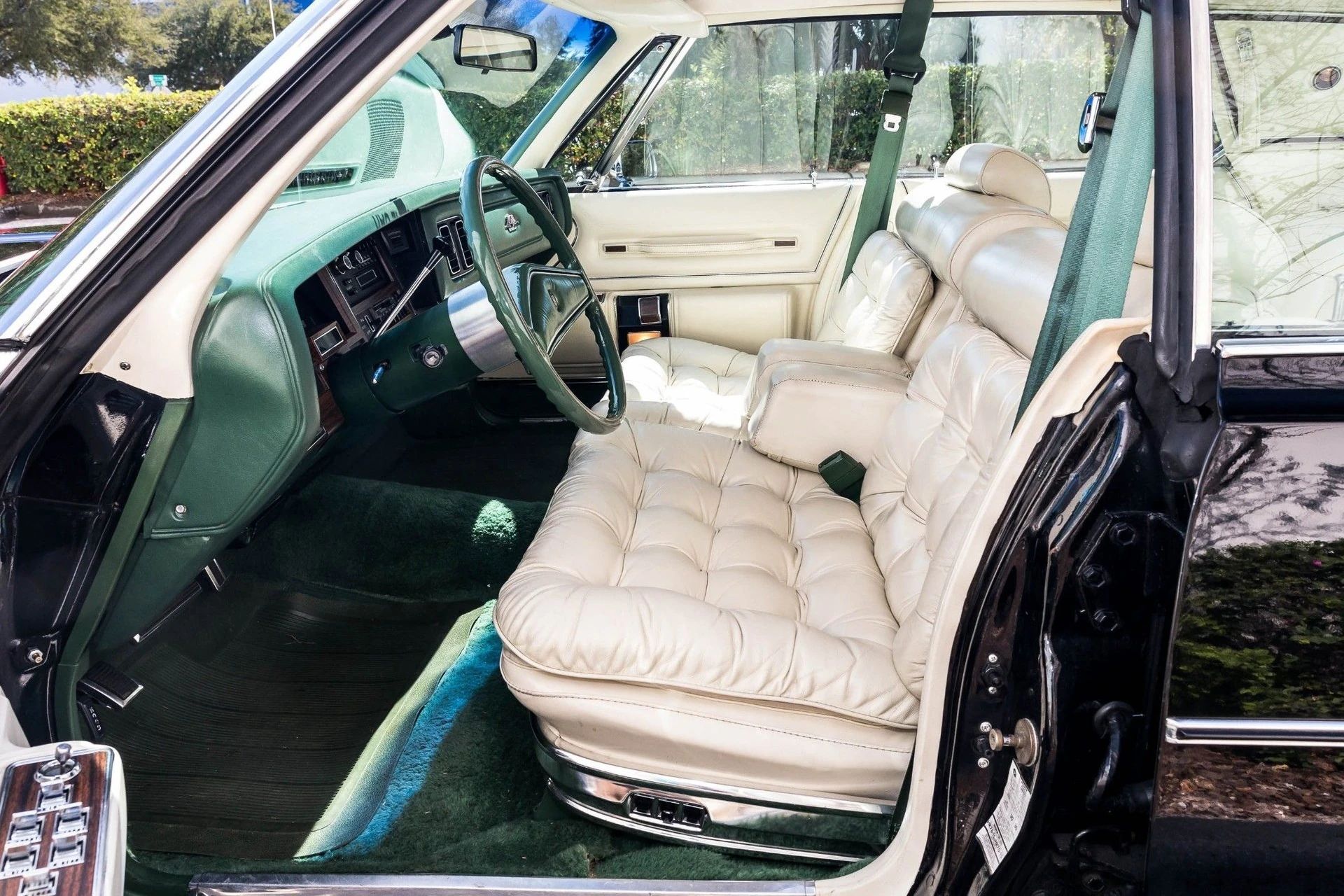 Front seat and dashboard of a 1978 Chrysler with pillowy leather seats, seen through the driver's door