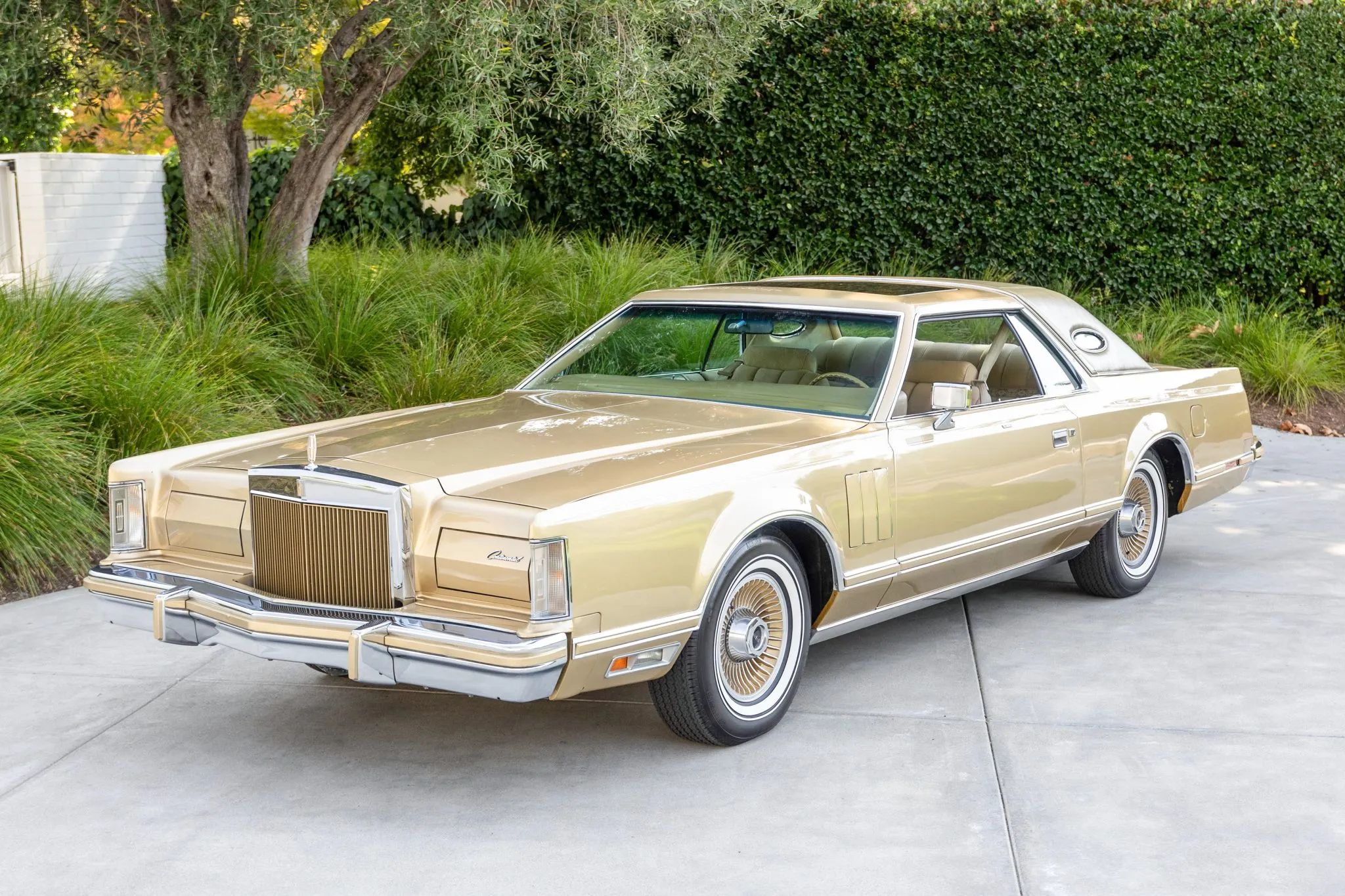 High-angle left front 3q view of a gold 1978 Lincoln Mark V