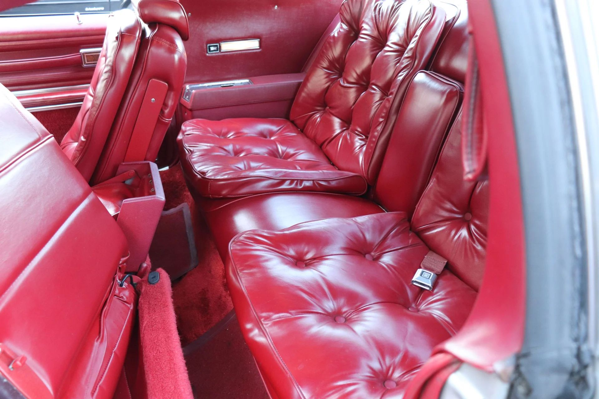 1978 Oldsmobile Toronado XS: Unusual Bent-Glass Special Edition Reinvents The 1947 Studebaker 23 Back seat of a 1978 Toronado XS, showing the driver's side seat back folded forward to access the cramped rear
