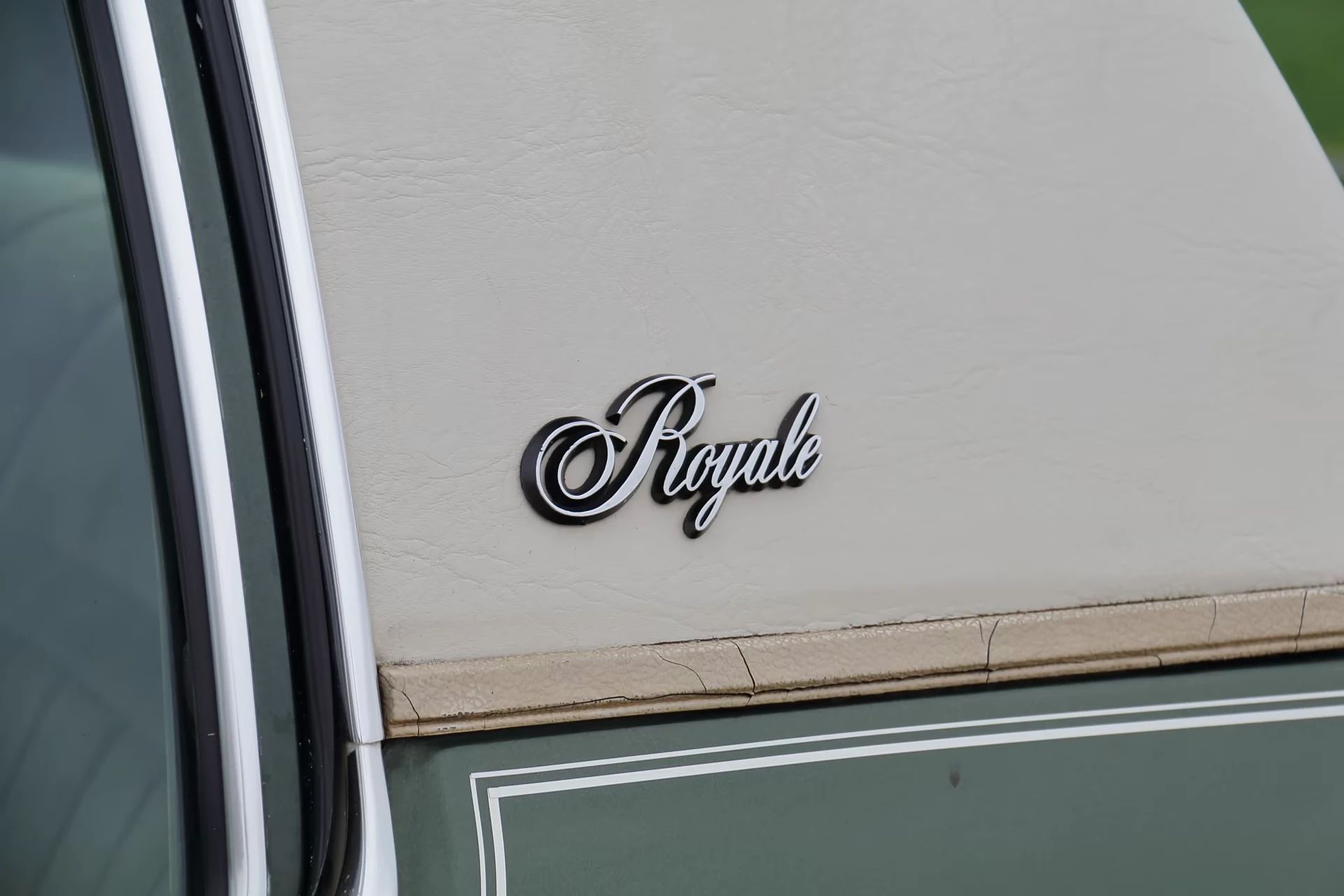 1980 Oldsmobile Delta 88 Royale Coupe With Diesel V-8: Disco-Era Diesel Survivor 17 Closeup of the "Royale" badge on the vinyl top of a 1980 Oldsmobile 88