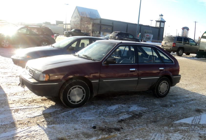 A 1988 Mercury Tracer in a parking lot
