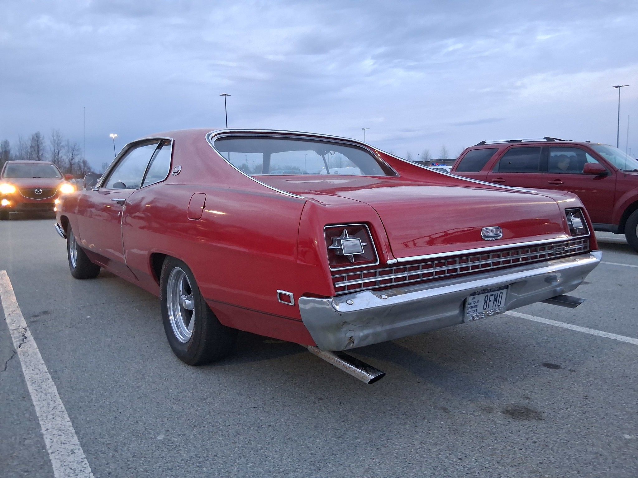 Red 1969 Ford XL from driver's rear three-quarter view