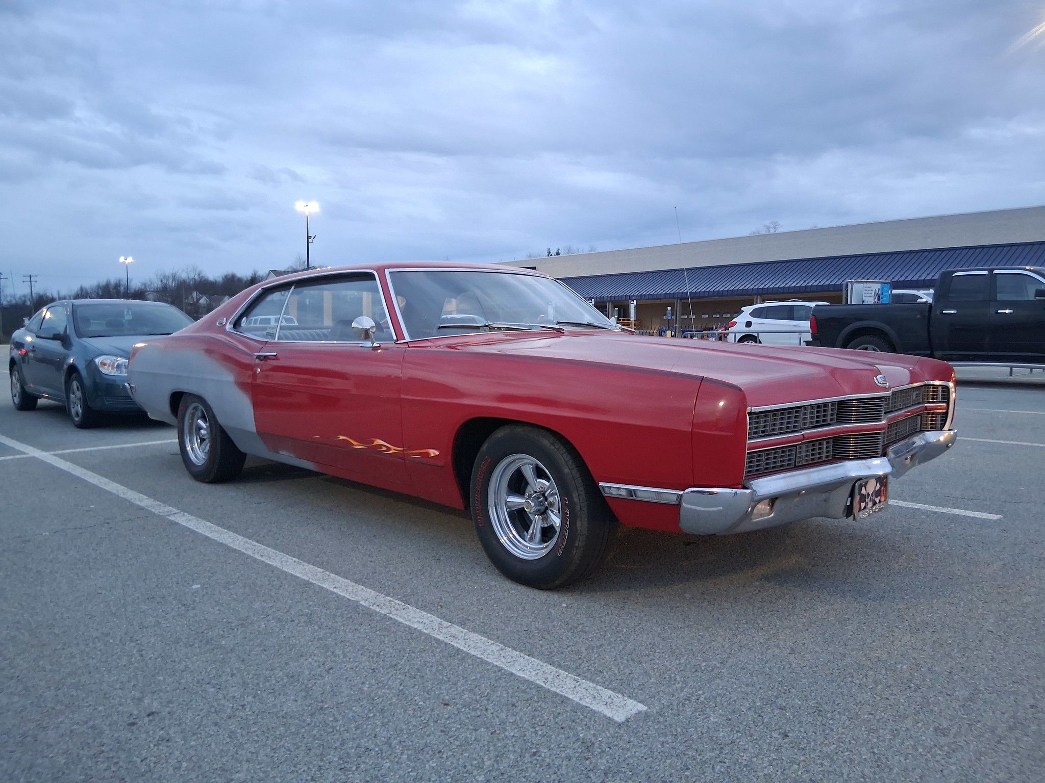 Passenger front three-quarter view of 1969 Ford XL in red and gray primer