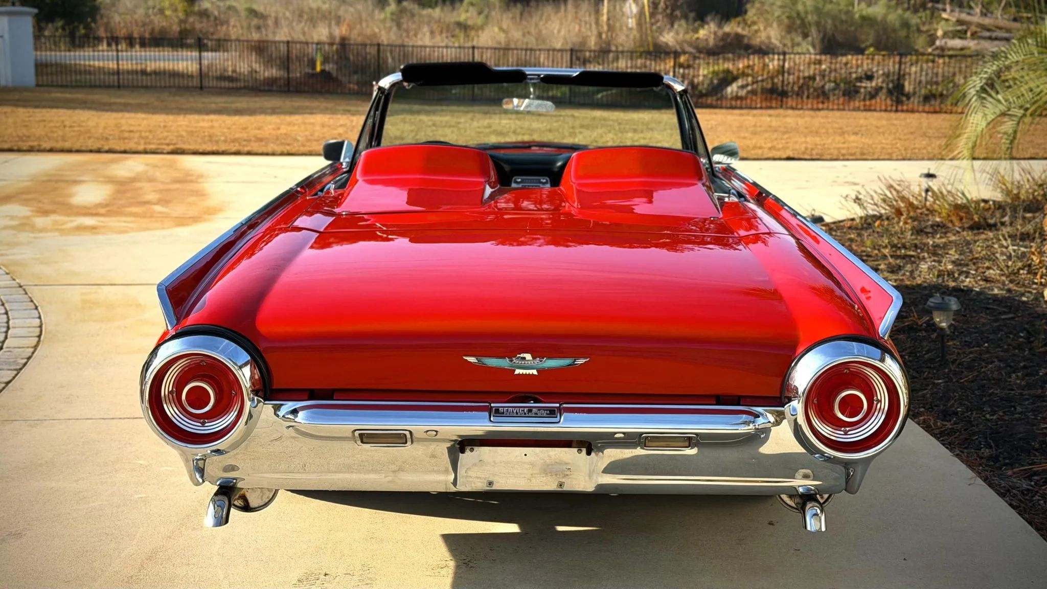 Rangoon Red 1962 Ford Thunderbird Sports Roadster rear view with top down
