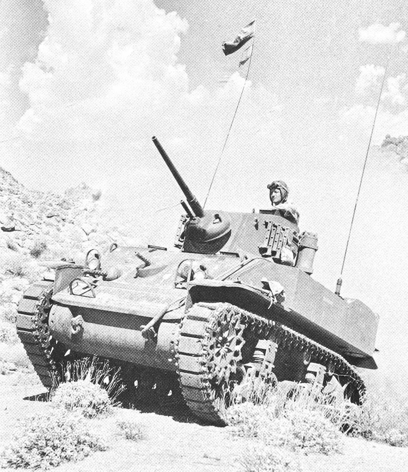 This WW2 Tank Is Powered By Twin Cadillac Engines And Hydra-Matic Transmissions, And It Was Parked Down The Street 5 B&W photo of a light tank climbing a hill