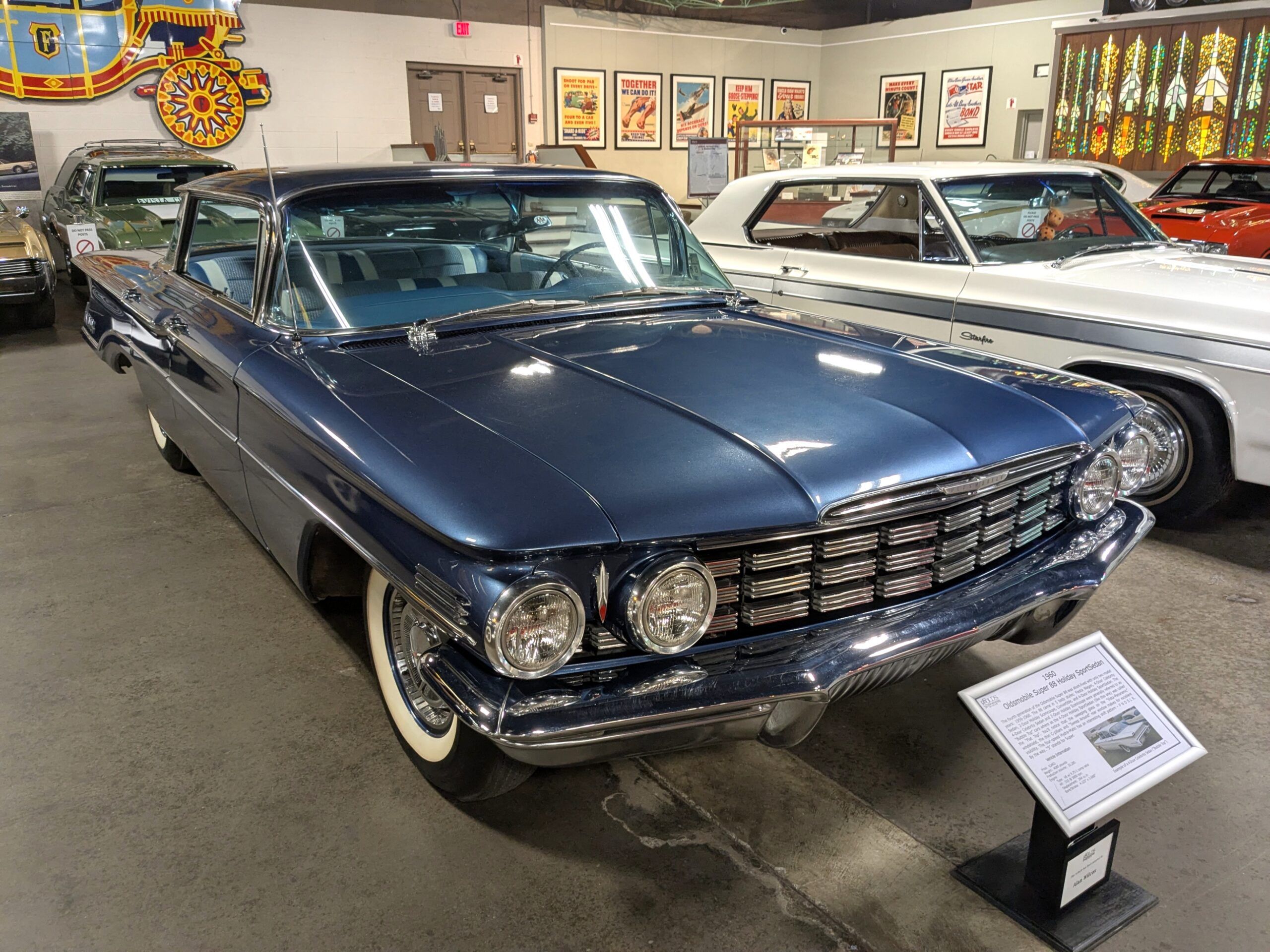 Blue 1960 Oldsmobile 88 from front passenger three-quarter view