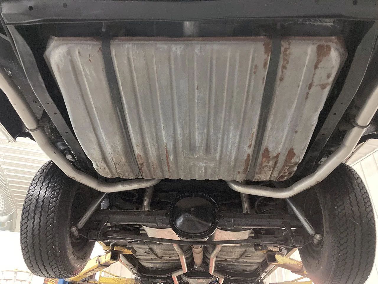 Rear suspension and fuel tank of a 1964 Oldsmobile 4-4-2, seen from below