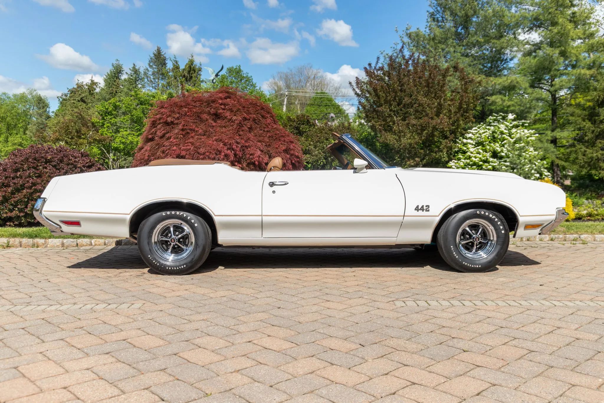 Right side view of a 1972 Oldsmobile Cutlass convertible with the top down