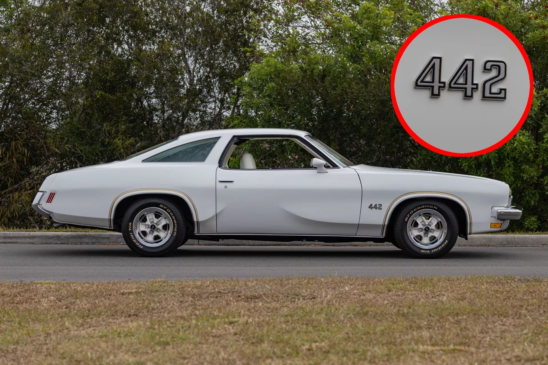 1973 Oldsmobile Cutlass S 4-4-2: What's In A Name (Or A Number?) 1 Right side view of a white 1973 Oldsmobile Cutlass S coupe with a circular inset showing a closeup of the 442 badge