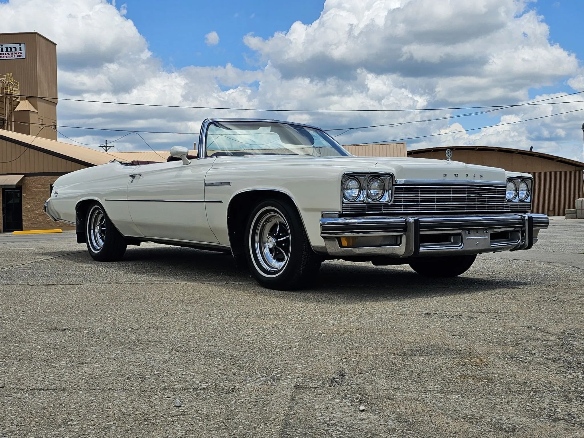 Low-angle right front 3q view of a 1975 Buick B-body convertible with the top down