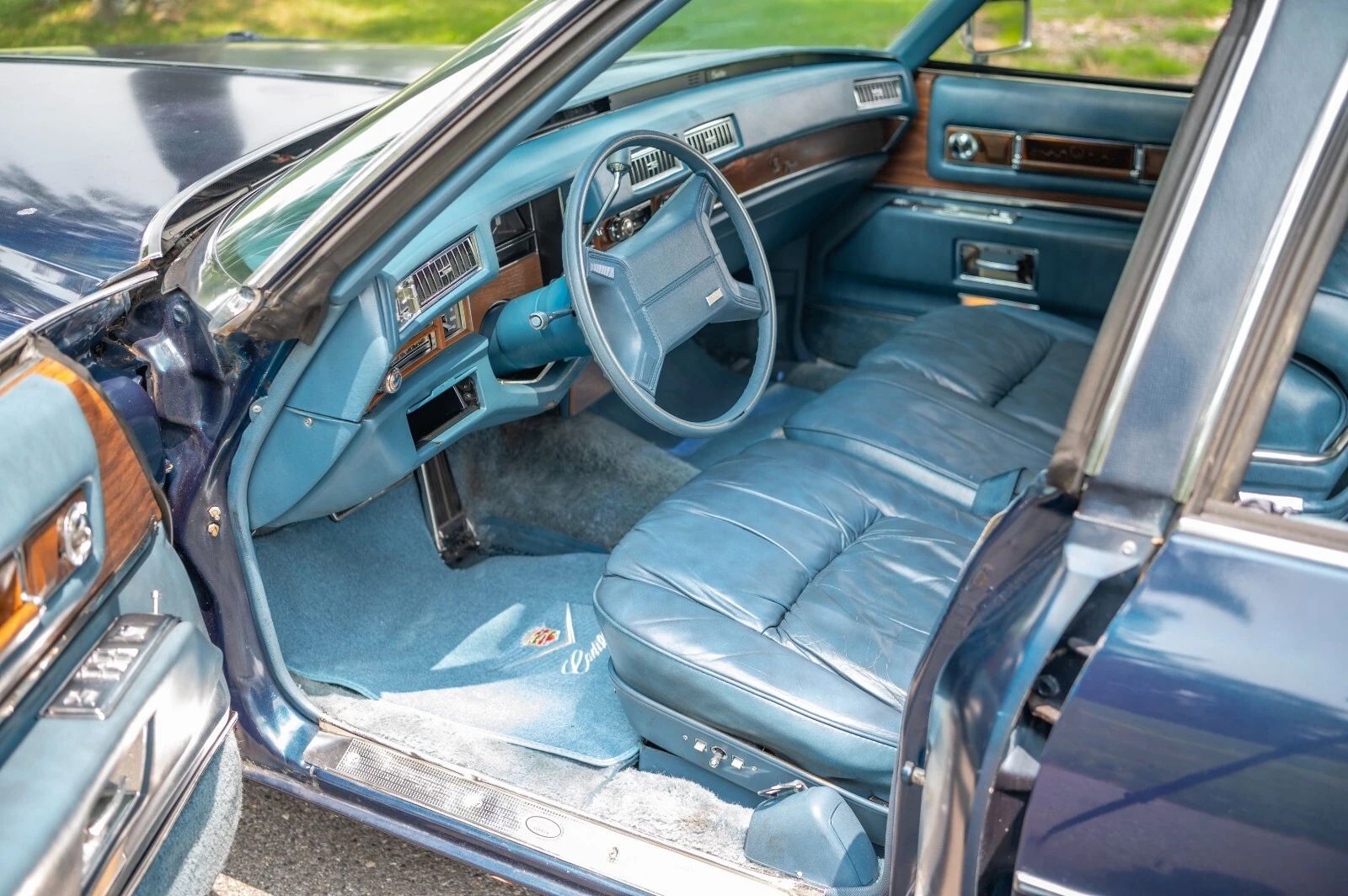 Left side of the dashboard of a 1975 Cadillac, seen through the driver's door