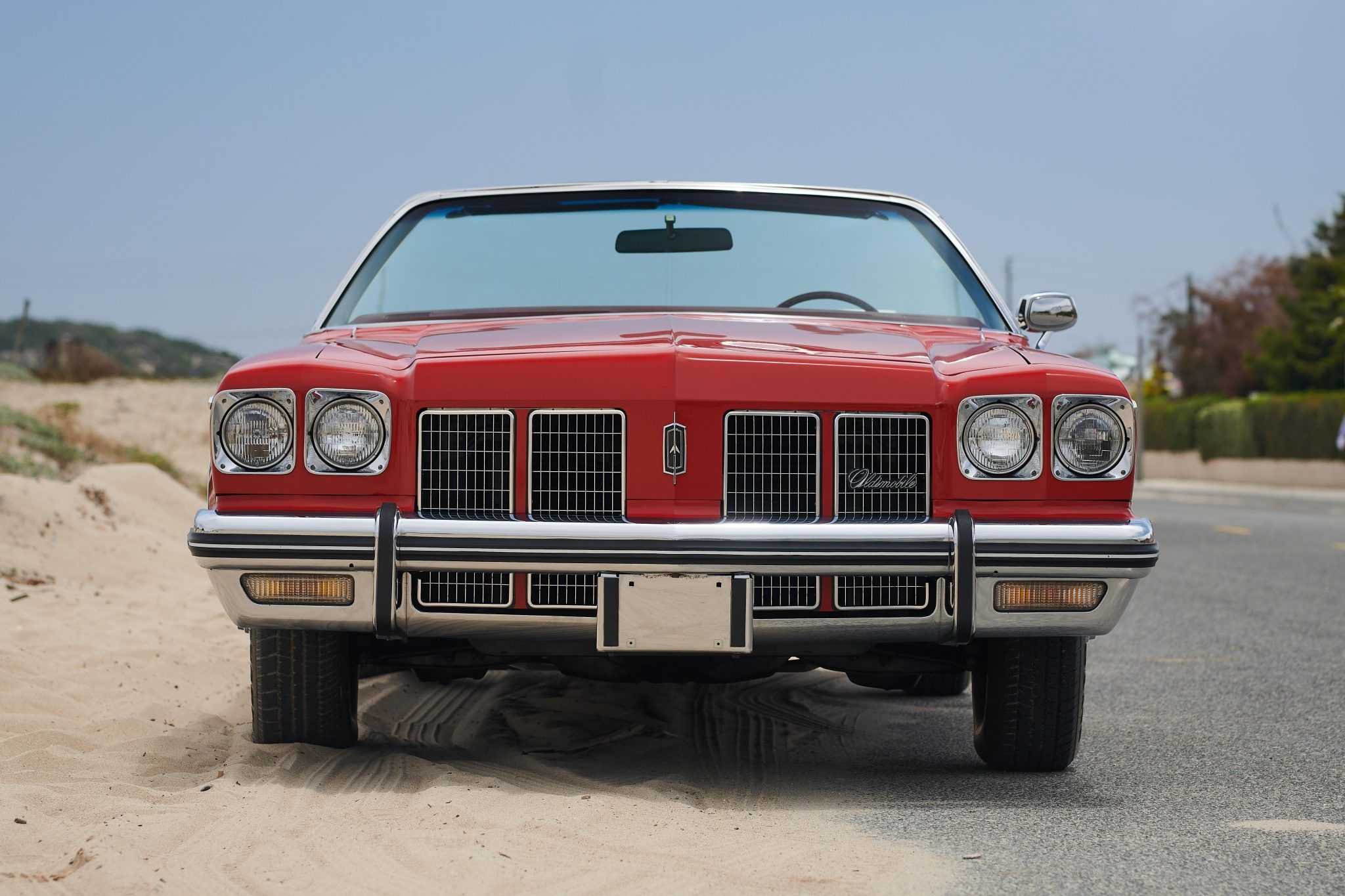 Front view of a 1975 Oldsmobile convertible with the top down