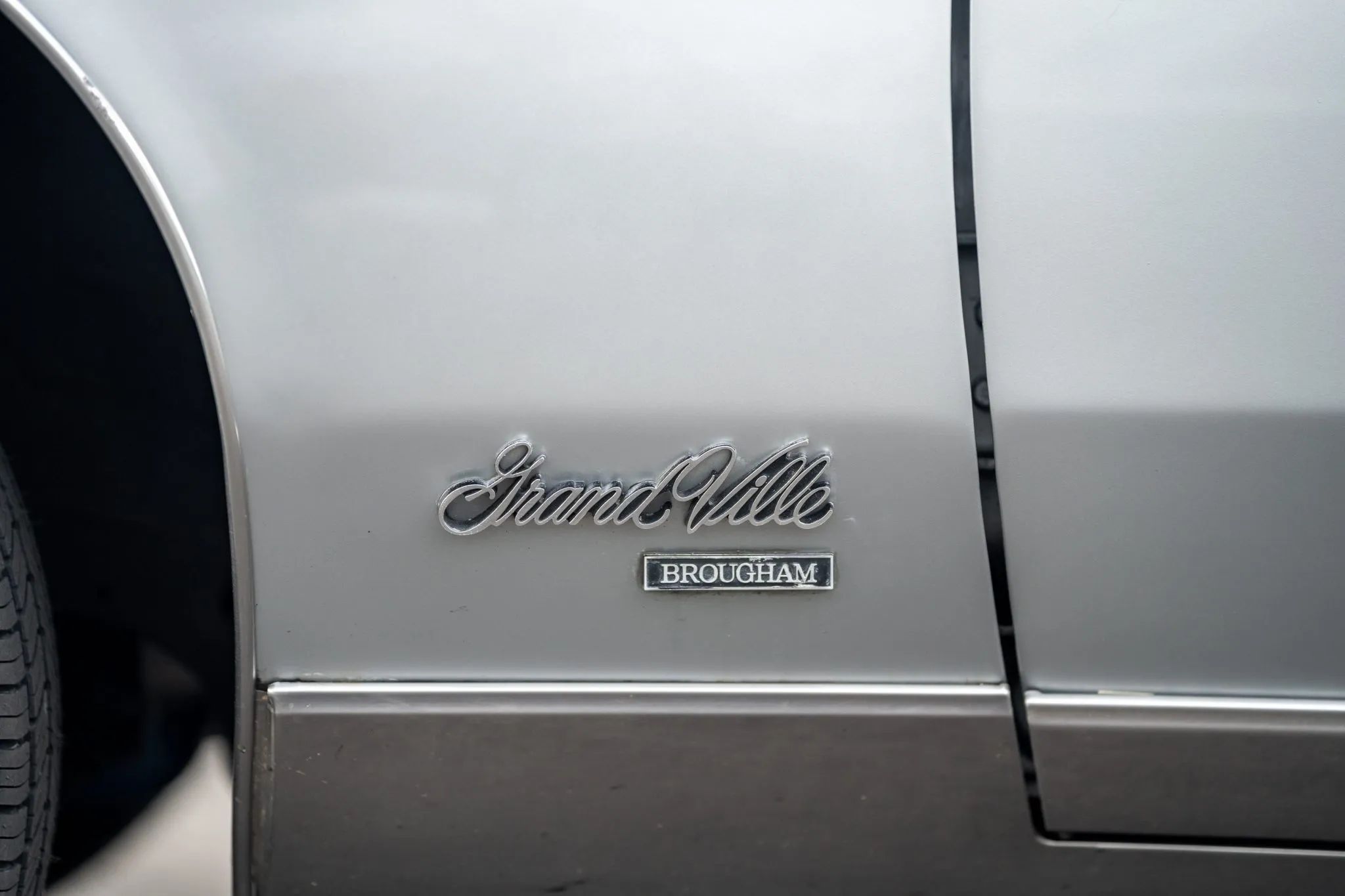Grand Ville Brougham badge on the fender of a Sterling Silver 1975 Pontiac